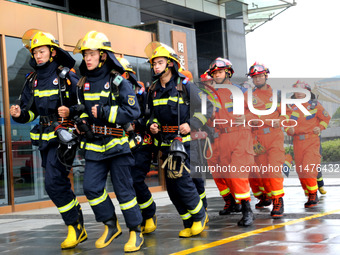 Fire personnel are conducting a firefighting drill at the scene of a high-rise building in Lianyungang, Jiangsu province, China, on August 1...