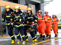 Fire personnel are conducting a firefighting drill at the scene of a high-rise building in Lianyungang, Jiangsu province, China, on August 1...