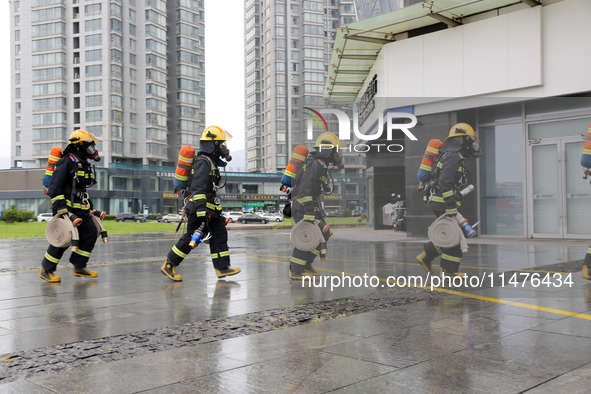 Fire personnel are conducting a firefighting drill at the scene of a high-rise building in Lianyungang, Jiangsu province, China, on August 1...