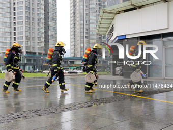 Fire personnel are conducting a firefighting drill at the scene of a high-rise building in Lianyungang, Jiangsu province, China, on August 1...