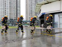 Fire personnel are conducting a firefighting drill at the scene of a high-rise building in Lianyungang, Jiangsu province, China, on August 1...