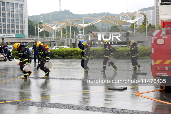 Fire personnel are conducting a firefighting drill at the scene of a high-rise building in Lianyungang, Jiangsu province, China, on August 1...