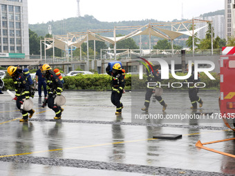 Fire personnel are conducting a firefighting drill at the scene of a high-rise building in Lianyungang, Jiangsu province, China, on August 1...