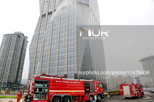 Fire personnel are conducting a firefighting drill at the scene of a high-rise building in Lianyungang, Jiangsu province, China, on August 1...