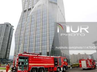 Fire personnel are conducting a firefighting drill at the scene of a high-rise building in Lianyungang, Jiangsu province, China, on August 1...