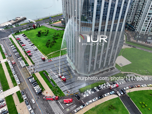 Fire personnel are conducting a firefighting drill at the scene of a high-rise building in Lianyungang, Jiangsu province, China, on August 1...