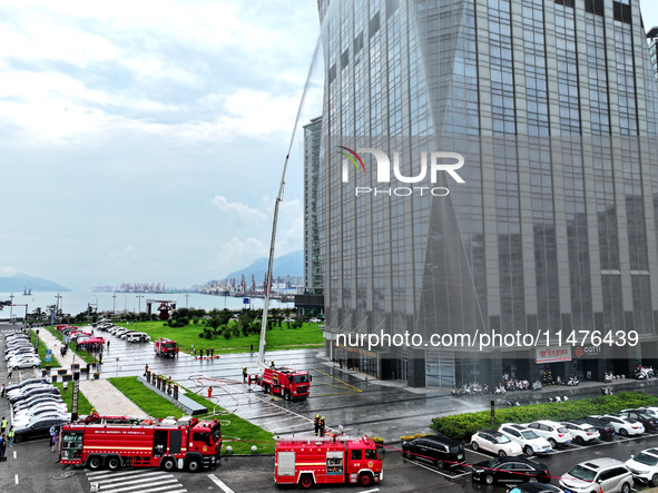 Fire personnel are conducting a firefighting drill at the scene of a high-rise building in Lianyungang, Jiangsu province, China, on August 1...