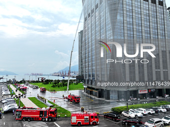 Fire personnel are conducting a firefighting drill at the scene of a high-rise building in Lianyungang, Jiangsu province, China, on August 1...