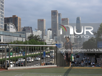 Pedestrians are riding on the streets of the CBD in Beijing, China, on August 14, 2024. (