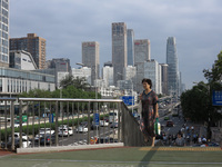 Pedestrians are riding on the streets of the CBD in Beijing, China, on August 14, 2024. (