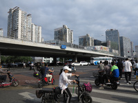 Pedestrians are riding on the streets of the CBD in Beijing, China, on August 14, 2024. (