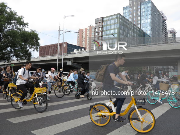 Pedestrians are riding on the streets of the CBD in Beijing, China, on August 14, 2024. 