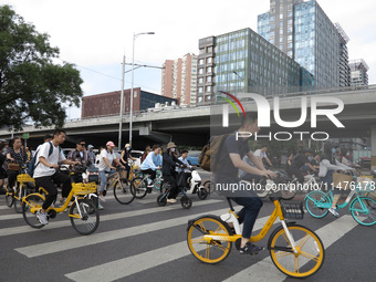 Pedestrians are riding on the streets of the CBD in Beijing, China, on August 14, 2024. (