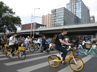 Pedestrians are riding on the streets of the CBD in Beijing, China, on August 14, 2024. (