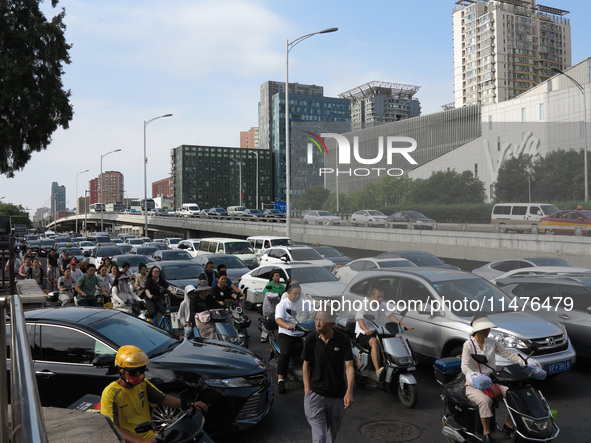 Pedestrians are riding on the streets of the CBD in Beijing, China, on August 14, 2024. 