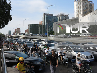 Pedestrians are riding on the streets of the CBD in Beijing, China, on August 14, 2024. (