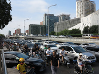 Pedestrians are riding on the streets of the CBD in Beijing, China, on August 14, 2024. (