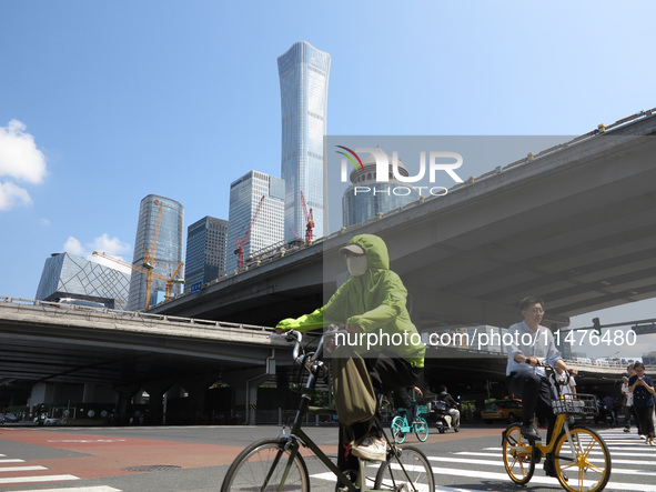 Pedestrians are riding on the streets of the CBD in Beijing, China, on August 14, 2024. 