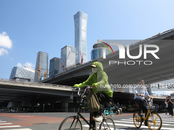 Pedestrians are riding on the streets of the CBD in Beijing, China, on August 14, 2024. (