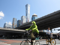 Pedestrians are riding on the streets of the CBD in Beijing, China, on August 14, 2024. (