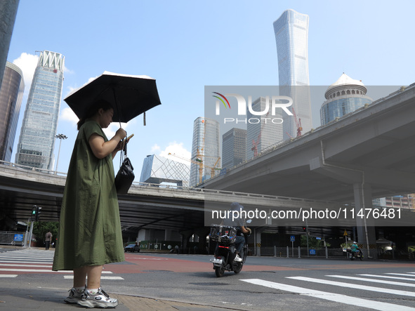 Pedestrians are riding on the streets of the CBD in Beijing, China, on August 14, 2024. 