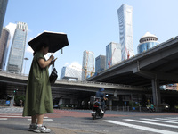 Pedestrians are riding on the streets of the CBD in Beijing, China, on August 14, 2024. (