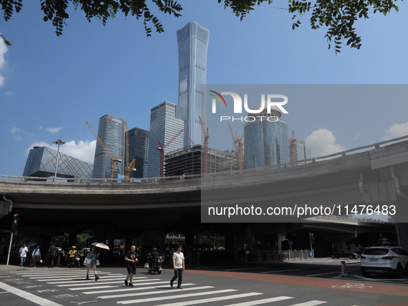 Pedestrians are riding on the streets of the CBD in Beijing, China, on August 14, 2024. 