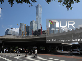 Pedestrians are riding on the streets of the CBD in Beijing, China, on August 14, 2024. (