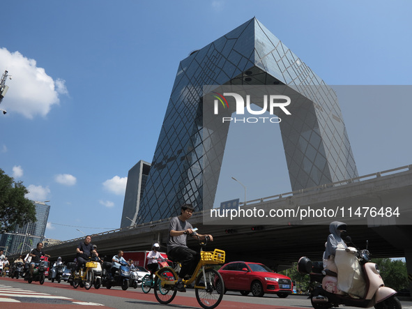 Pedestrians are riding on the streets of the CBD in Beijing, China, on August 14, 2024. 