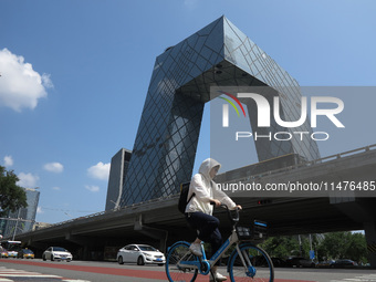 Pedestrians are riding on the streets of the CBD in Beijing, China, on August 14, 2024. (