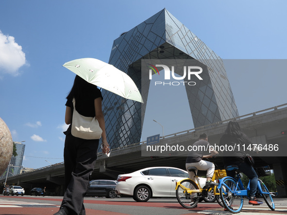 Pedestrians are riding on the streets of the CBD in Beijing, China, on August 14, 2024. 