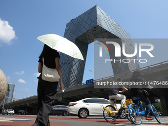 Pedestrians are riding on the streets of the CBD in Beijing, China, on August 14, 2024. (