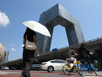 Pedestrians are riding on the streets of the CBD in Beijing, China, on August 14, 2024. (