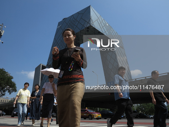 Pedestrians are riding on the streets of the CBD in Beijing, China, on August 14, 2024. 