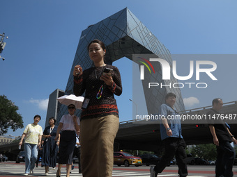 Pedestrians are riding on the streets of the CBD in Beijing, China, on August 14, 2024. (