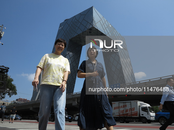 Pedestrians are riding on the streets of the CBD in Beijing, China, on August 14, 2024. 