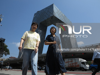 Pedestrians are riding on the streets of the CBD in Beijing, China, on August 14, 2024. (