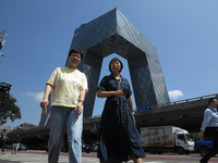 Pedestrians are riding on the streets of the CBD in Beijing, China, on August 14, 2024. (