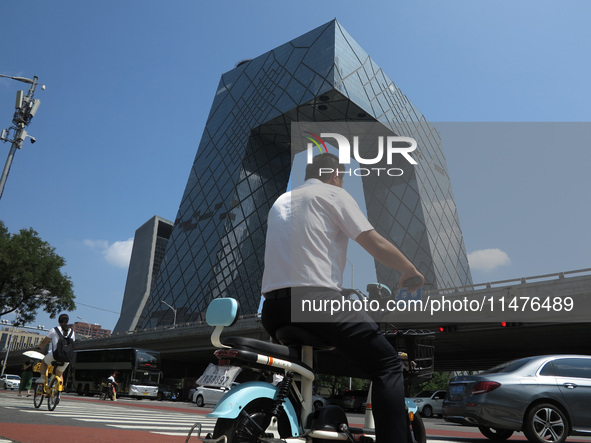 Pedestrians are riding on the streets of the CBD in Beijing, China, on August 14, 2024. 