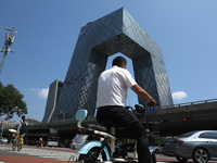 Pedestrians are riding on the streets of the CBD in Beijing, China, on August 14, 2024. (