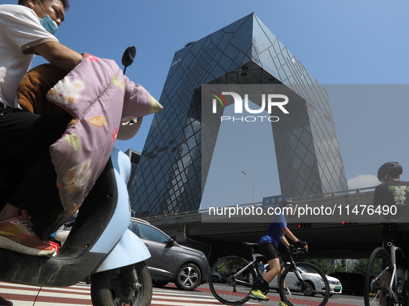 Pedestrians are riding on the streets of the CBD in Beijing, China, on August 14, 2024. 