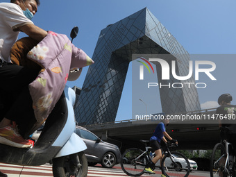 Pedestrians are riding on the streets of the CBD in Beijing, China, on August 14, 2024. (