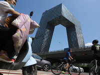 Pedestrians are riding on the streets of the CBD in Beijing, China, on August 14, 2024. (