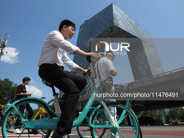 Pedestrians are riding on the streets of the CBD in Beijing, China, on August 14, 2024. 