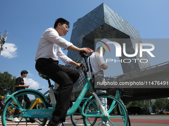 Pedestrians are riding on the streets of the CBD in Beijing, China, on August 14, 2024. (