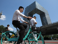 Pedestrians are riding on the streets of the CBD in Beijing, China, on August 14, 2024. (