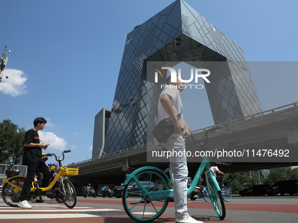 Pedestrians are riding on the streets of the CBD in Beijing, China, on August 14, 2024. 