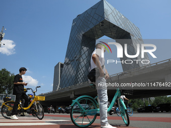 Pedestrians are riding on the streets of the CBD in Beijing, China, on August 14, 2024. (