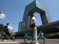 Pedestrians are riding on the streets of the CBD in Beijing, China, on August 14, 2024. (