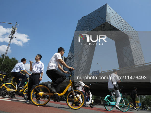 Pedestrians are riding on the streets of the CBD in Beijing, China, on August 14, 2024. 